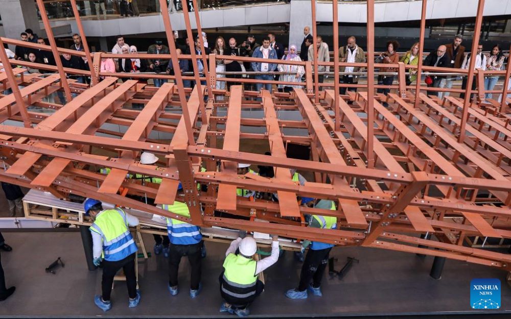 The restoration team work on the restoration project for the ancient King Khufu's second solar boat at the Grand Egyptian Museum in Cairo, Egypt, Dec. 23, 2025. Egypt on Tuesday began reassembling ancient King Khufu's second solar boat at the newly opened Grand Egyptian Museum, a restoration process expected to take about four years and open for visitors to watch live.