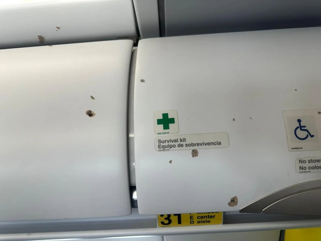 An image shows damage to the interior of the Spirit Airlines plane.