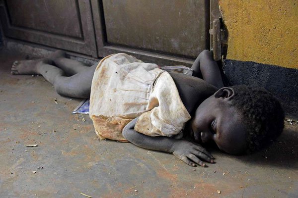 A newly arrived refugee child from South Sudan sleeping on a dirty floor on the Ugandan side of the Ngomoromo border post on April 10, 2017. More than 375,000 South Sudanese have fled to Sudan since the outbreak of civil war in 2013.