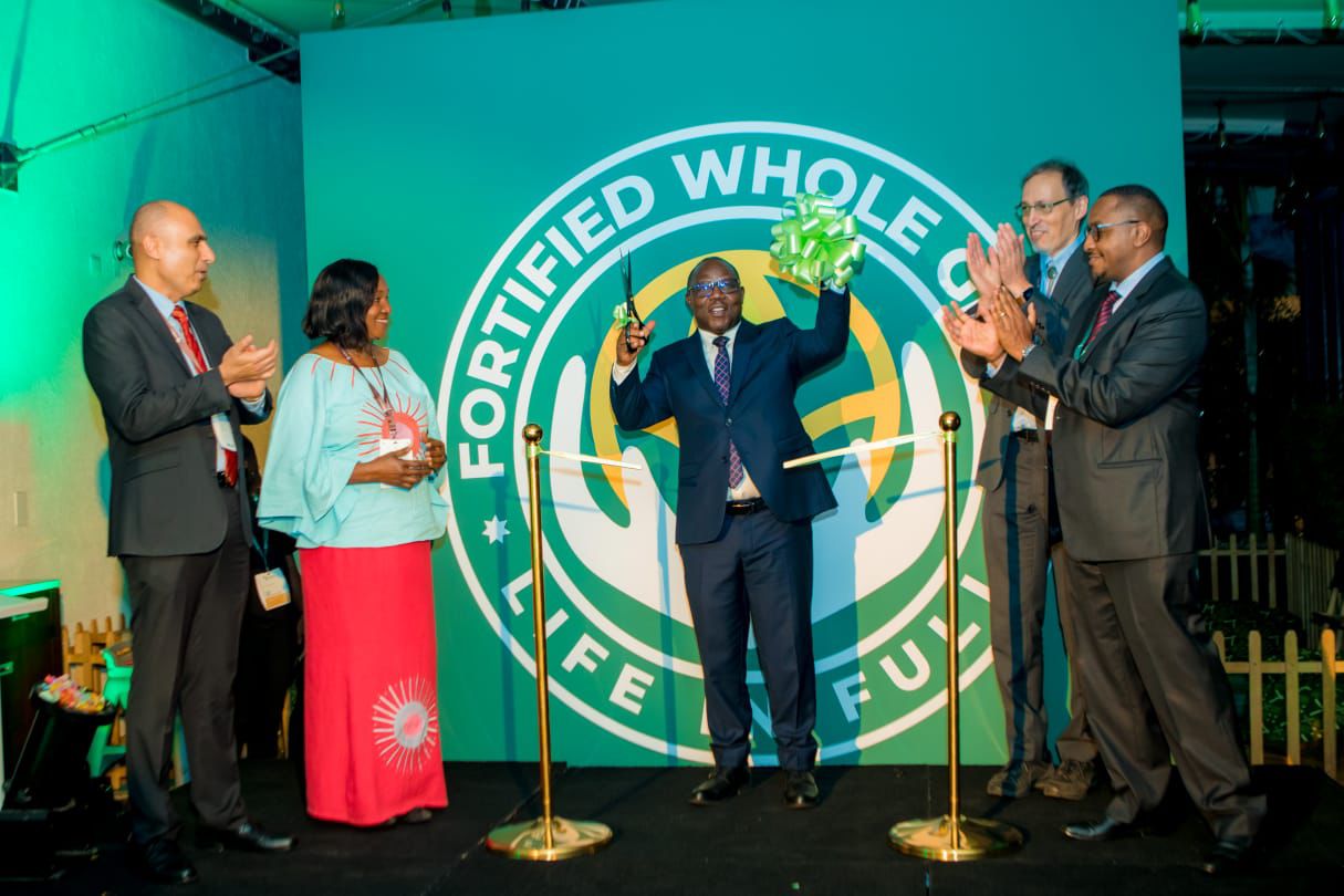 Local Government Minister Jean Claude Musabyimana addresses participants at the Fortified Whole Grain Alliance (FWGA) official launch in the company of David Kamau (FWGA), Roy Steiner, Peiman Milani, and Betty Kibaara of the Rockefeller Foundation.