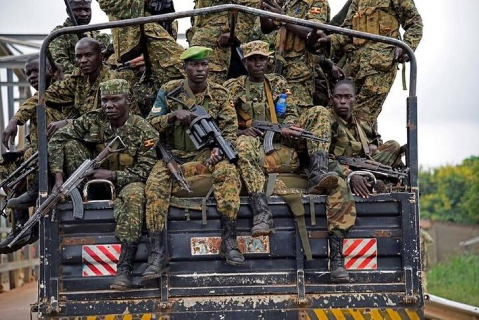 Uganda People's Defence Forces (UPDF) soldiers ride atop their military truck.