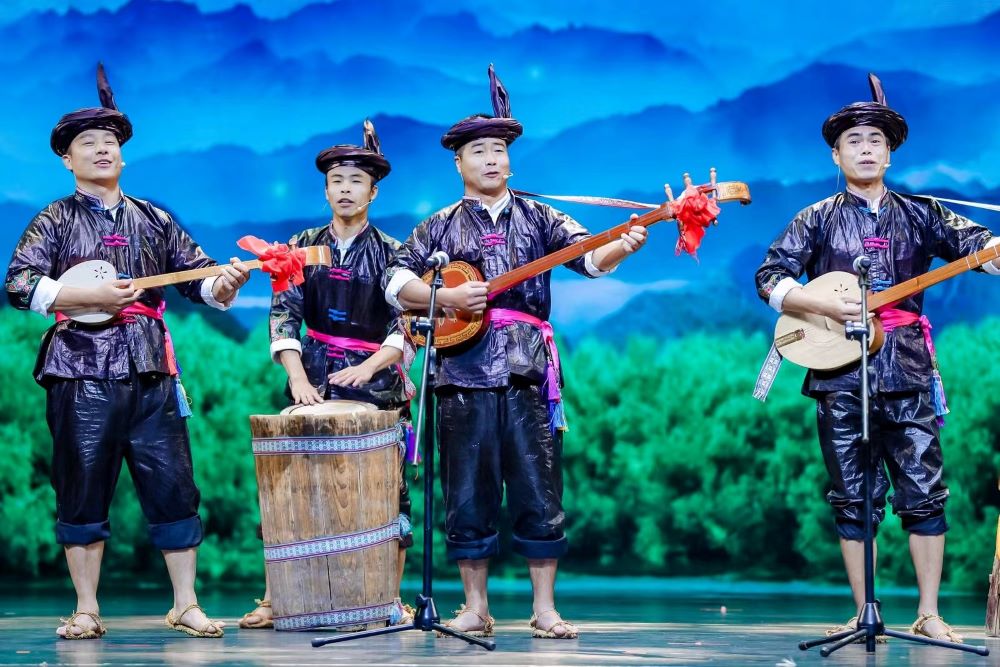 The Dong people play guitar-like instruments that blend ancient melodies with modern rhythms.