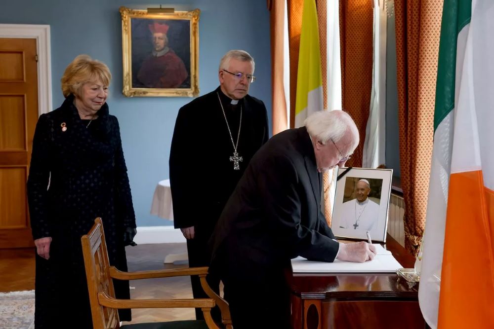 President Michael D Higgins and his wife Sabina, with the Papal Nuncio Archbishop Luis Mariano Montemayor, signing a Book of Condolences for Pope Francis, at the Holy See Apostolic Nunciature in Dublin.
