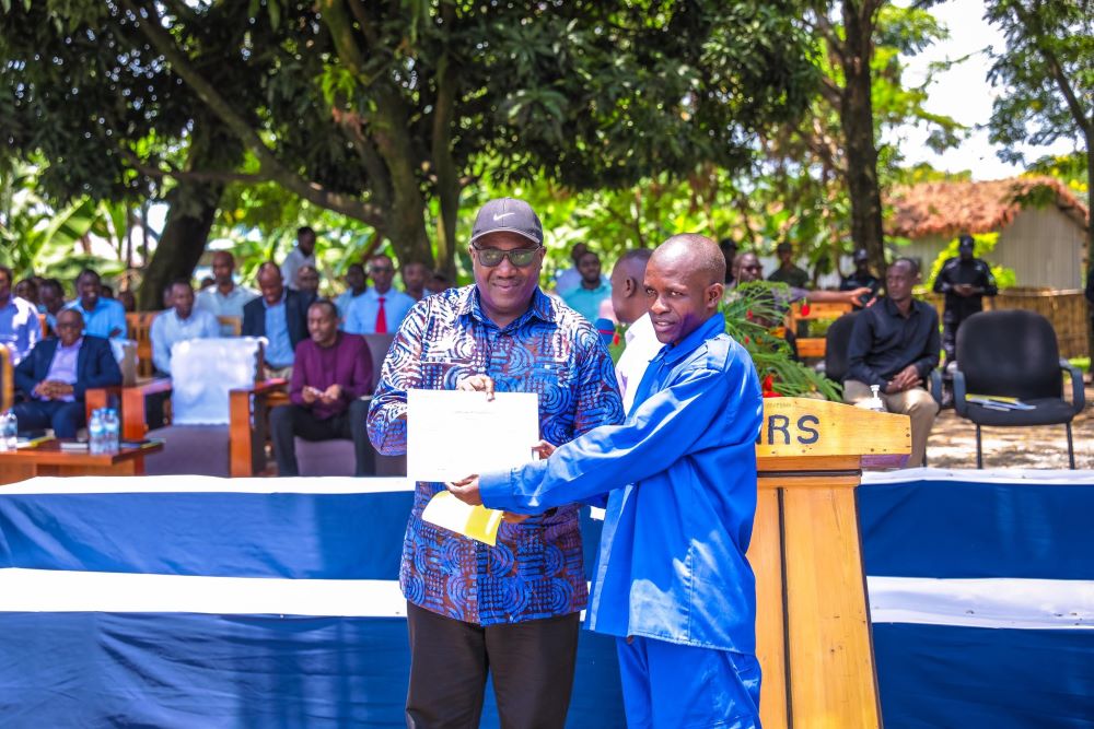 Minister of Local Government, Dr. Patrice Mugenzi appreciates one of the graduates.