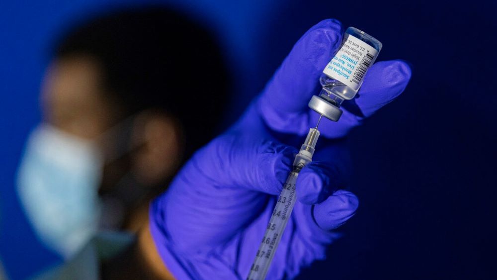 A health worker prepares a syringe with the mpox vaccine.