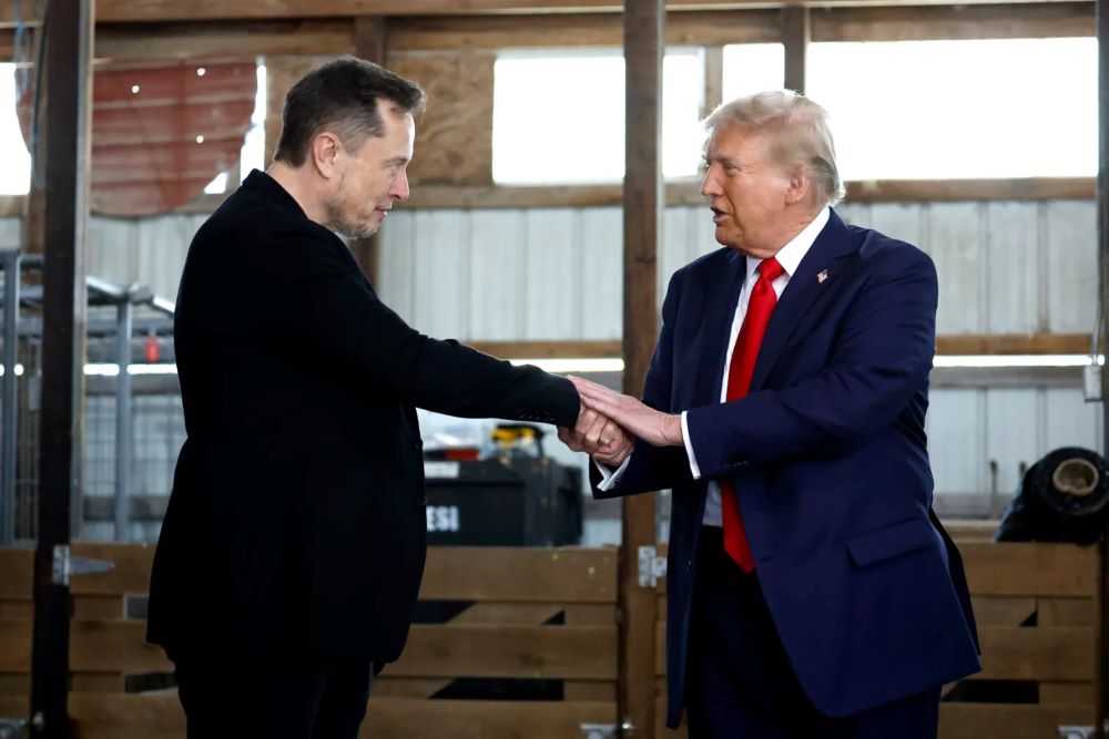 Elon Musk shakes hands with Donald Trump during a campaign rally at the Butler Farm Show grounds on Oct. 5, 2024 in Butler, Pennsylvania.