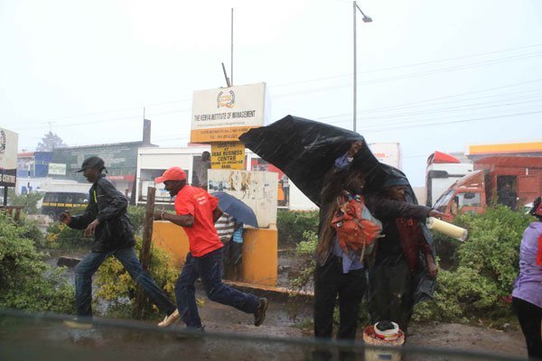 Nyeri residents disperse from President Uhuru Kenyatta'a meeting after a heavy downpour pounded the area on January 20, 2017.