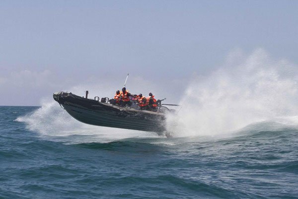 Ugandan African Union Mission to Somalia Marines patrol along the country's Indian Ocean coastline on March 3, 2014 off Mogadishu. An oil tanker with eight Sri Lankan crew members aboard has been hijacked off the coast of Somalia.