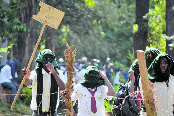 Maseno School students hold placards in protest of the interdiction of the school principal Paul Otula on March 15, 2017.