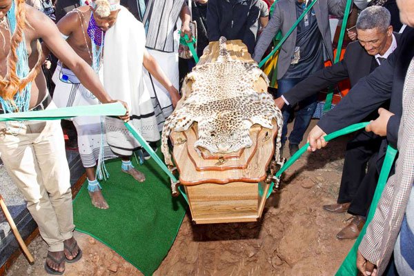 People carry the coffin as activists, community members, relatives and government officials attend the burial ceremony of Khoisan traditional leader and freedom fighter David Stuurman on June 16, 2017 in Hankey, South Africa.