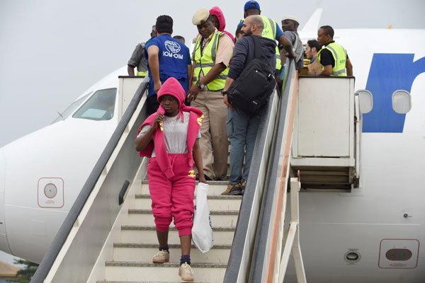 A young female migrant disembarks from a chartered aircraft that returned 155 stranded Nigerian migrants from Libya at Murtala Mohammed International Airport in Lagos, on March 23, 2017.