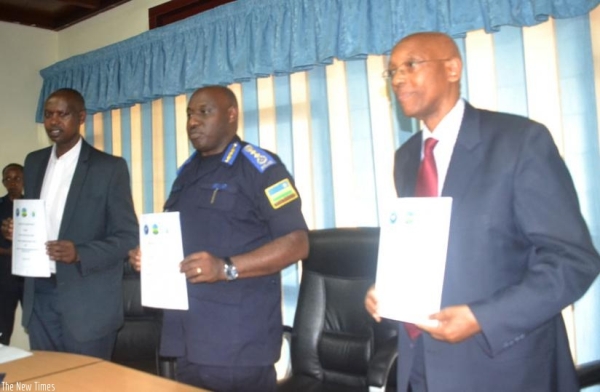L-R: Augustin Katabarwa, the chairman of NCCR, IGP Emmanuel K. Gasana and Damien Mugabo, the director-general of RCA, display copies of the MoU they signed yesterday. (Courtesy)