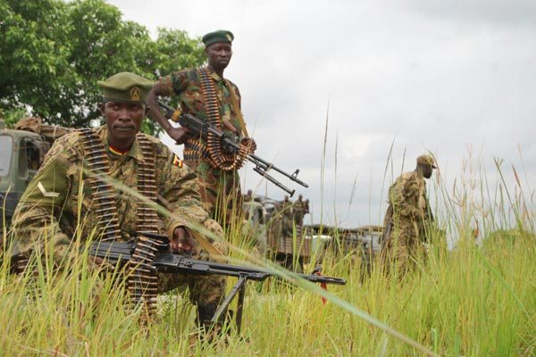 UPDF soldiers take cover at Moli village towards Aruu Junction in South Sudan after their convoy came under attack on July 14.