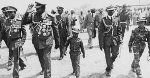 Former president Idi Amin (2nd L) walks with his commanders and sons at a public function in the 1970s. This week marked 37 years since the Tanzanian army and Uganda exiles toppled