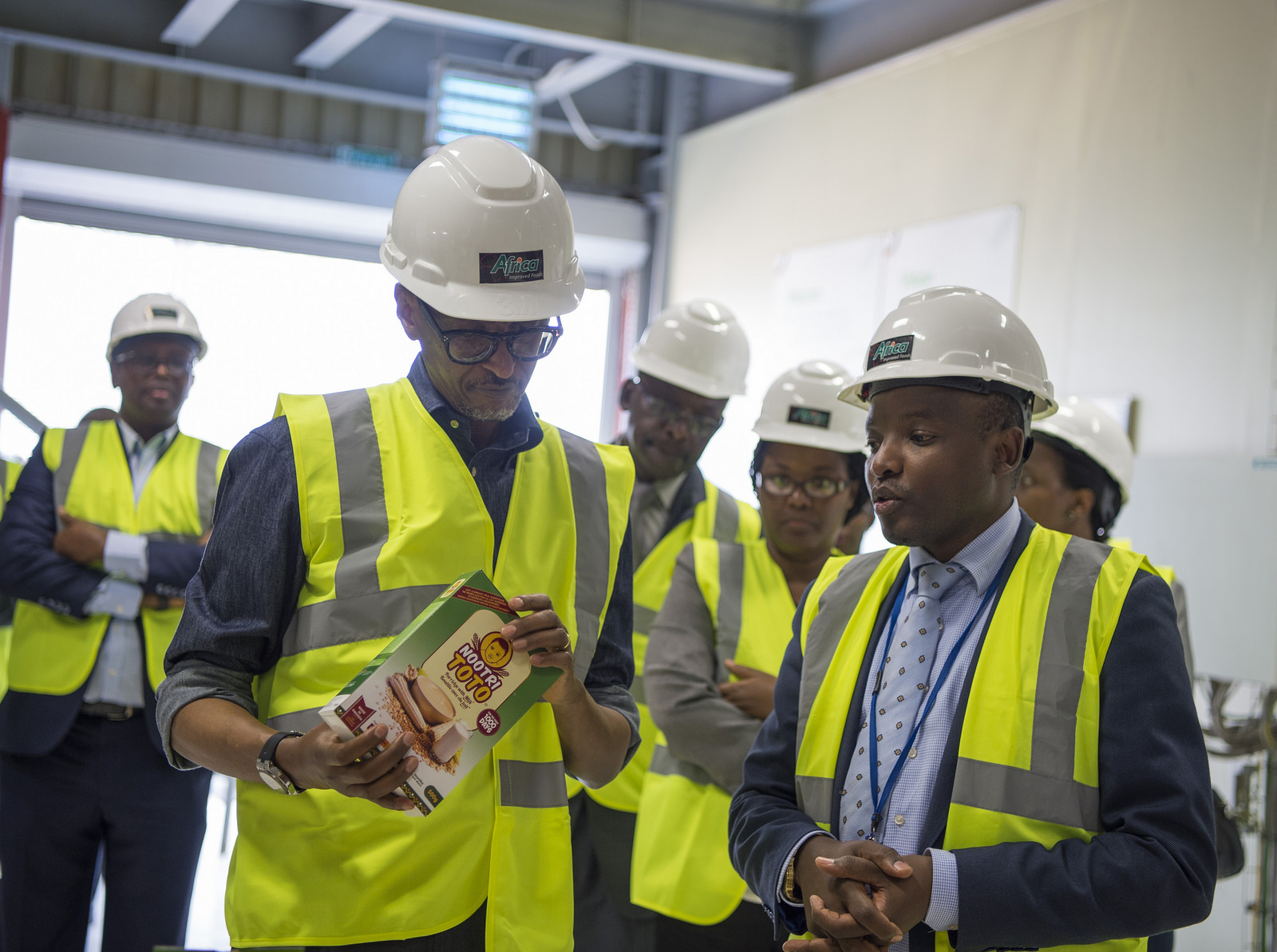 President Paul Kagame takes a close look at Nootritoto, one of AIF Rwanda's commercial products during a brief tour of the plant.