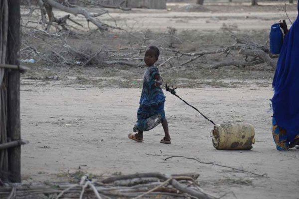 A girl pulls a jerrycan that was filled after a water tank brought water to Korisa location, Ijara, Garissa county.