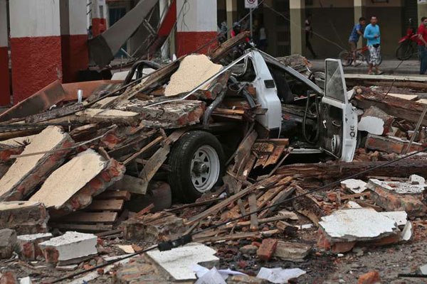 View of a vehicle squashed by rubble after a 7.8-magnitude quake in Portoviejo, Ecuador on April 17, 2016.