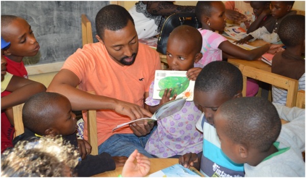 Gasana reading to children at the Kigali Reading Center in Rwanda. (Photo courtesy of Parfait Gasana)