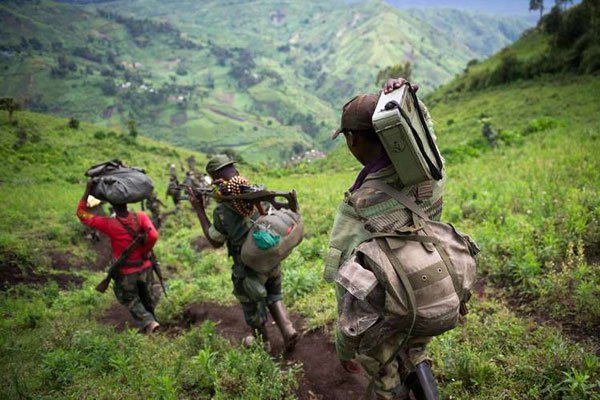 M23 rebels leave their position in the village of Karuba, eastern Democratic Republic of Congo, on November 30, 2012. DR Congo blames shadowy rebel group for a two-year wave of massacres in a restive corner of DR Congo centres.