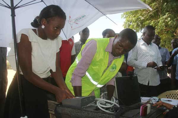 IEBC clerk helps a voter to register at Free Hall, Mombasa County on January 16, 2017.