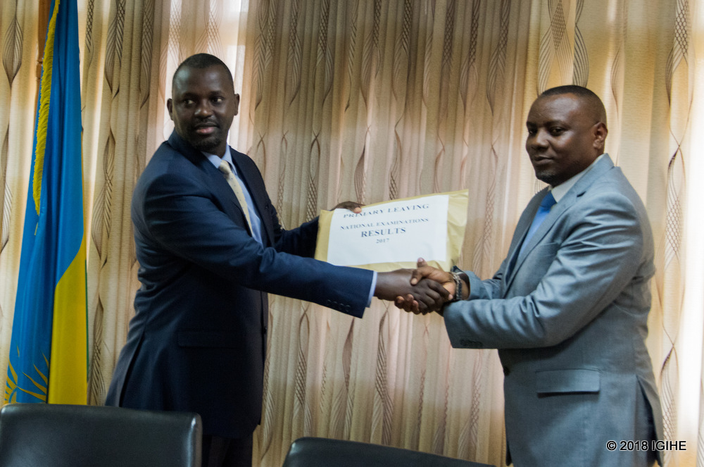 State Minister for Primary and Secondary Education, Dr. Isaac Munyakazi (R) receives examination results from Rwanda Education Board Director General Janvier Gasana