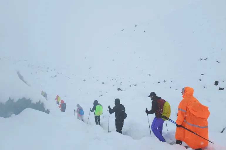 A screen capture from video shows trekkers leaving their campsite, as unusually heavy snow and rainfall pummeled the Himalayas, in the Tibet Region, China, on Sunday, October 5, 2025.