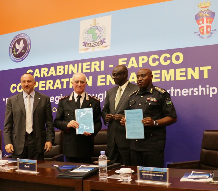 Lt. Gen. Tullio Del Sette and IGP Emmanuel K. Gasana displaying copies of the signed MoU as Minister Johnston Busingye and Italy's ambassador to Rwanda, Domenico Fornara look on.