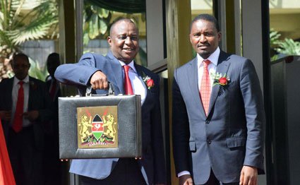 National Treasury Cabinet Secretary Henry Rotich (left) and his Devolution and Planning counterpart Mwangi Kiunjuri at the Treasury offices in Nairobi before he presented the budget for the 2016/17 financial year to Parliament on June 8, 2016.
