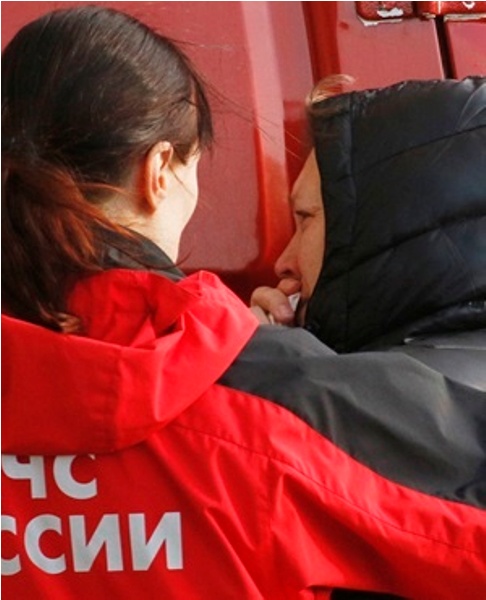 A Russian emergency doctor comforts a relative of a passenger aboard the crashed Russian airline