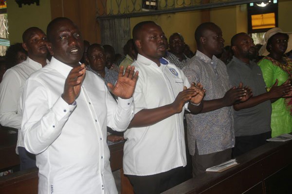 Deputy President William Ruto (left) attending Sunday mass at Mombasa's Holy Ghost Cathedral church on February 5, 2017.