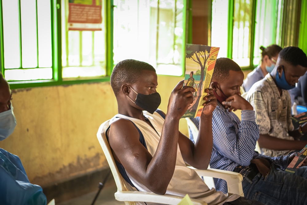 Young father reading the leaflet in Kicukiro district.