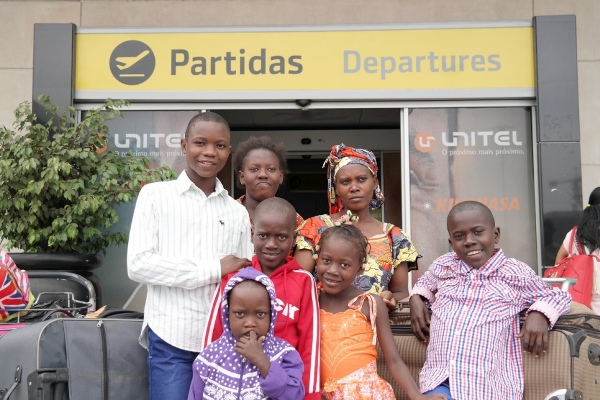 Musabyemariya Fratenata and her children at the airport in Angola prior to their departure for Rwanda.