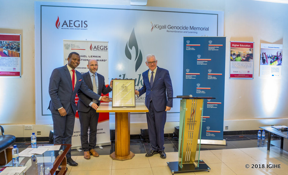 Poland Foreign Affairs Minister, Jacek Czaputowicz (R) presents the award to Aegis Trust