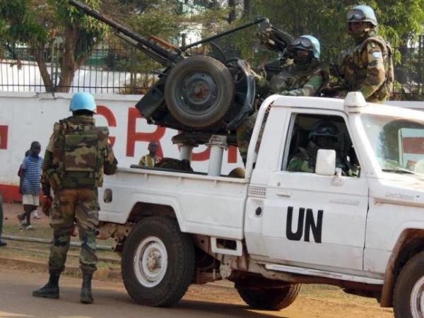 U.N. peacekeepers take a break as they patrol along a street during the presidential election in Bangui, the capital of Central African Republic, December 30, 2015.