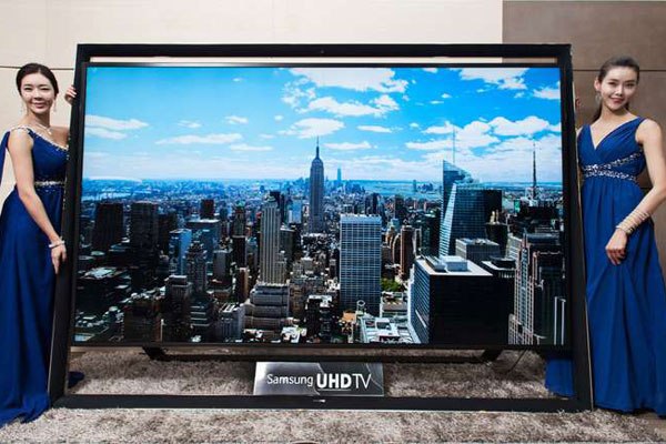 A photo shows models posing with Samsung's largest Ultra HD television, a 110-inch UHD TV, featuring ultra-high definition - four-times better resolution compared to a full-HD display. South Korea which was at par economically with Kenya in 1963, now is the 15th most prosperous country in the world