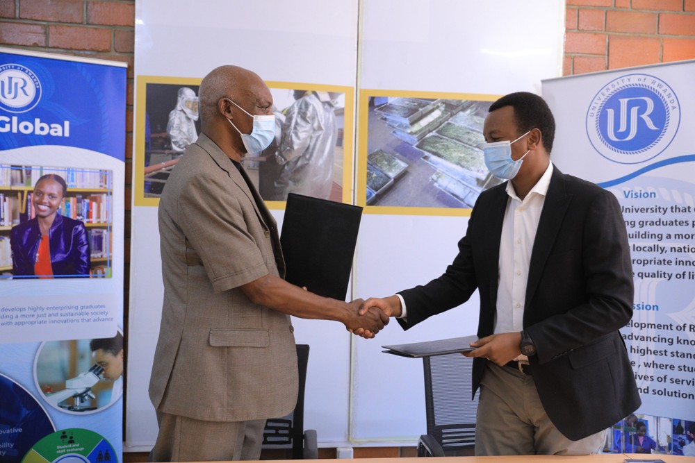 The Vice Chancellor of the University of Rwanda, Professor Alexandre Lyambabaje (left) exchanging documents with Joseph Butera, the Deputy Managing Director at LuNa Smelter after signing the MoU. 
