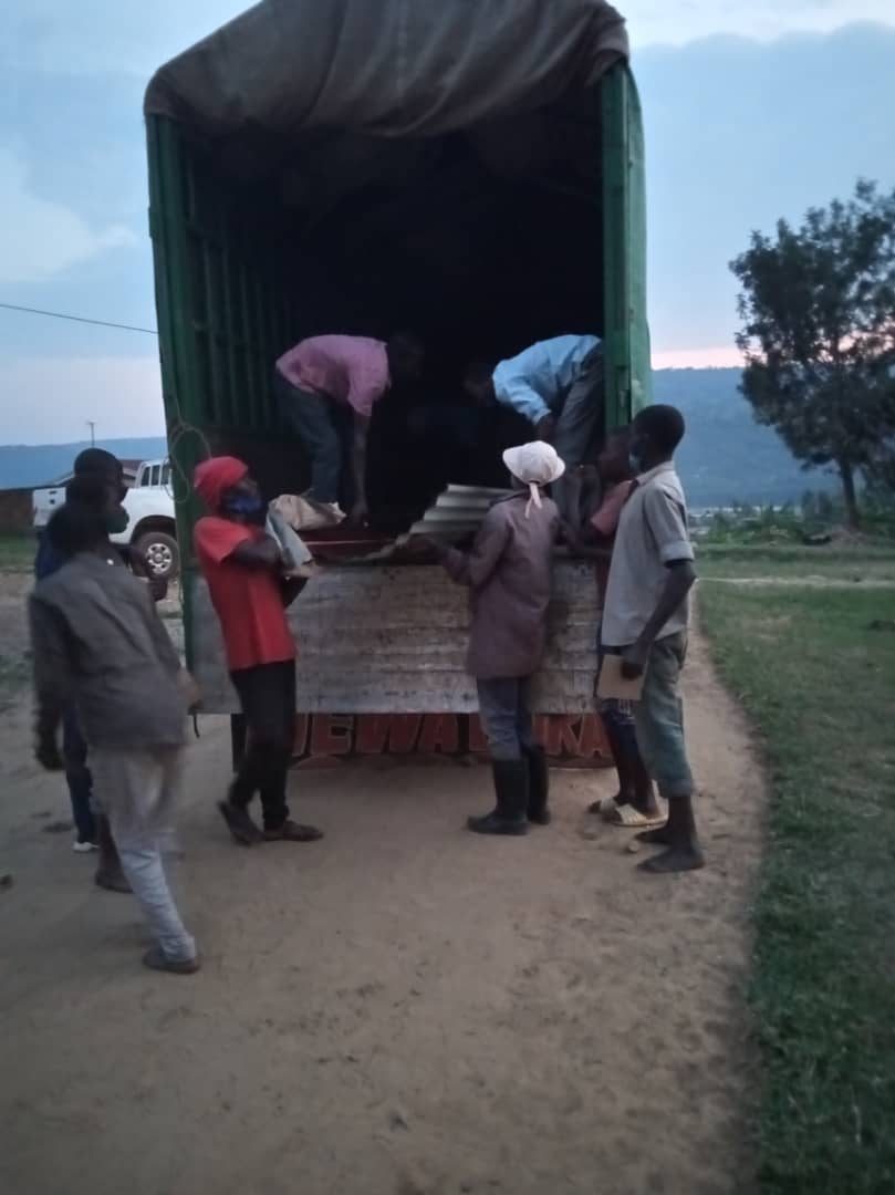 Residents offloading roofing sheets.  