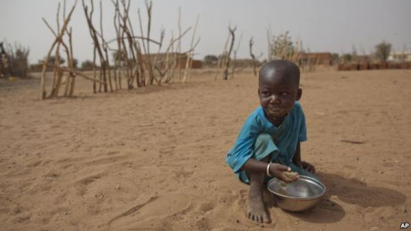 А boy is seen eating dry couscous in the village of Goudoude Diobe, in the Matam region of northeastern Senegal.