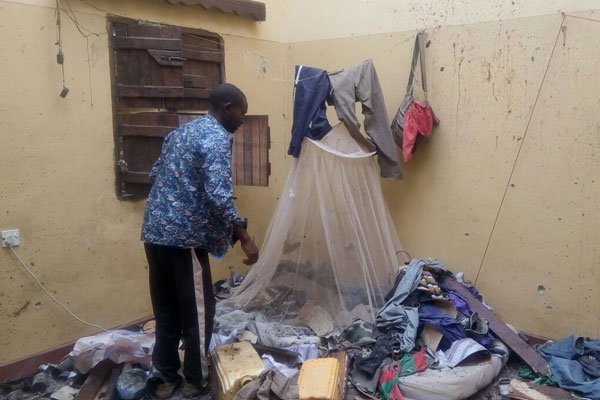 David Kimani, a survivor, searches for his belongings in one of rooms attacked by Al-Shabaab. He said he hung on the ceiling until the militants left the room.
