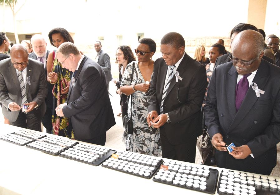 Attendees light candles at an event on April 30, 2017 at Kibbutz Tel Yitzhak marking the 1994 genocide in which more than one million Tutsis were killed in Rwanda. (photo credit:ZOHAR TSABARI)