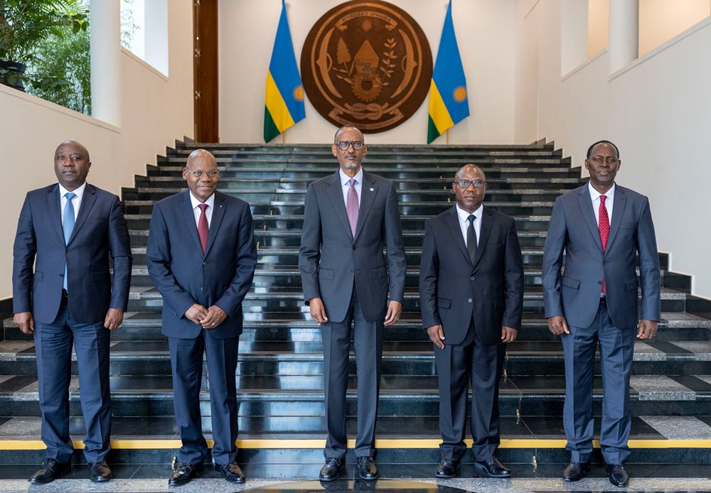 President Paul Kagame (in the middle) with the newly sworn-in minister ( second from right) in a group photo with other top government officials after the ceremony. 