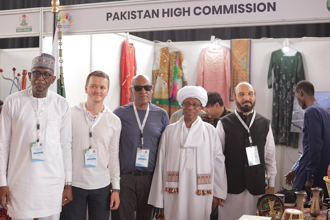 Envoys pose for a photo outside a stall by the Pakistan High Commission.