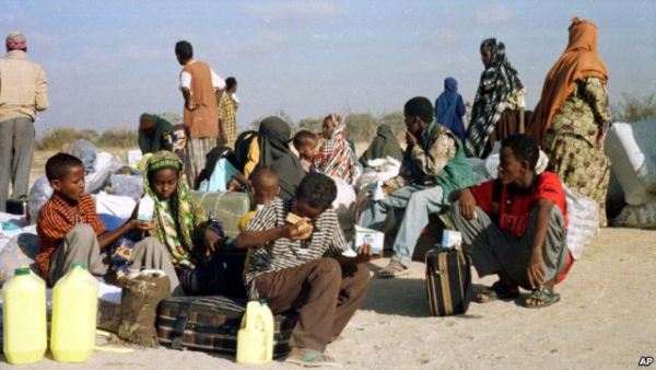 Somali refugees wait for a plane to take them home from Dabaab refugee camp in northern Kenya, Feb. 21, 2000.