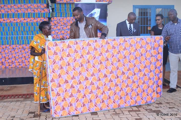 SONARWA staff handing over mattress donations to one of genocide survivors in Gasabo district yesterday