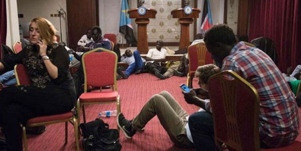 Journalists sat inside a conference room as artillery fire broke out near the presidential palace in Juba on July 8, 2016. The fighting further strained a shaky ceasefire a day after five soldiers were killed.