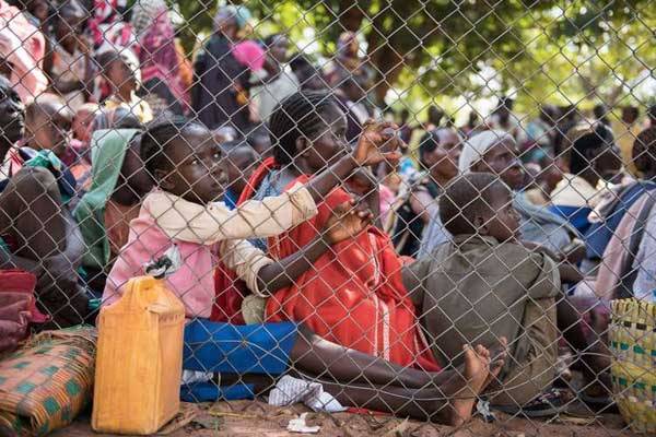 Displaced people wait for food in Wau, South Sudan, on July 3, 2016 following fighting in the area. A rights group says peacekeepers left their posts during an attack on a UN-protected site in the capital Juba by government troops.