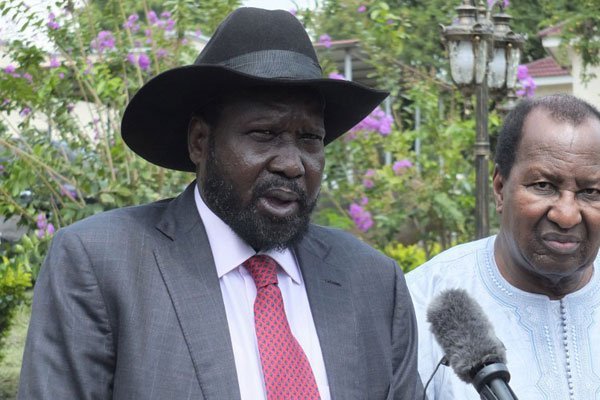 South Sudanese President Salva Kiir (left), flanked by African Union special envoy and former Malian President Alpha Oumar Konare (right), talks to the media on July 14, 2016 at the presidential palace in Juba. A recent flare-up of deadly violence in South Sudan will dominate the agenda as heads of state gather Sunday for a key African Union summit in Kigali. 
