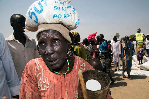 A woman carries a sack of food at a stabilisation centre in Panyijiar, South Sudan, on March 4, 2017. Famine is affecting about 100,000 people in the country.