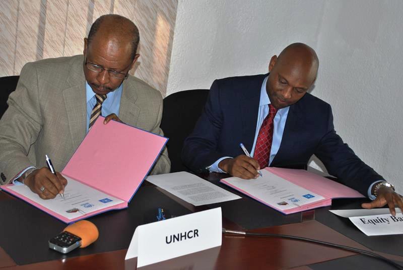 UNHCR and Equity bank representatives signing the agreement