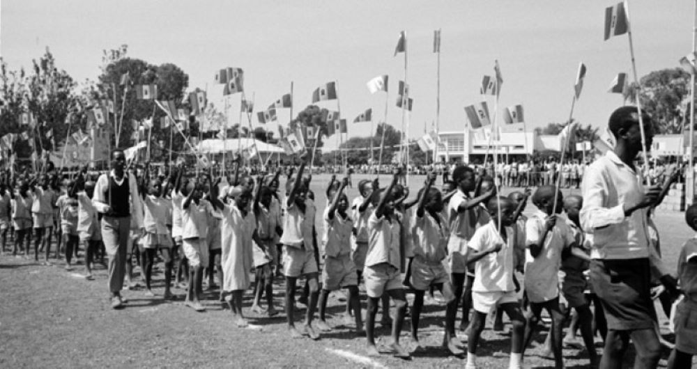 After the Independence Day speech, students marched proudly with paper flags, and local leaders wore sashes in the colors of the new Rwandan flag.